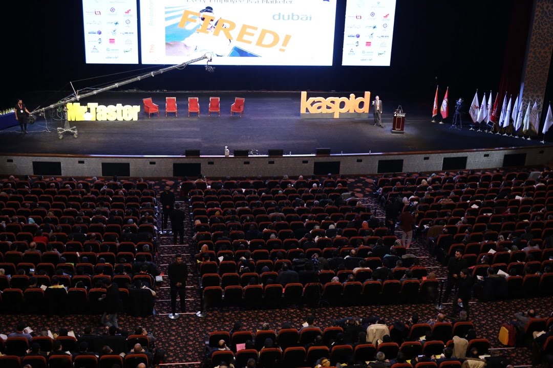Prof. Christian Farioli speaking on stage in an auditorium